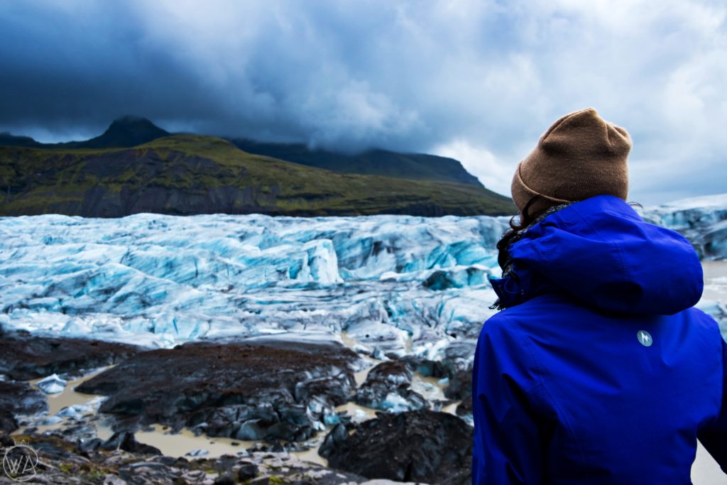 Girl looking at Svínafellsjökull glacier Iceland 